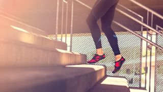 Woman climbing stars wearing Vivobarefoot shoes