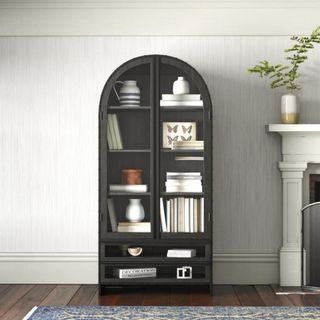 A black arched cabinet with glass doors from Wayfair