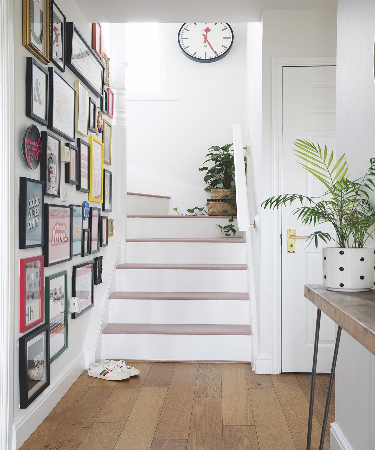White staircase with wooden treads and entryway bench