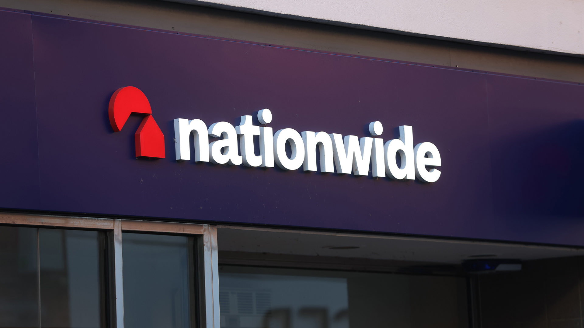 Nationwide Building Society logo and branding pictured on the facade of a high street branch in Altrincham, United Kingdom.