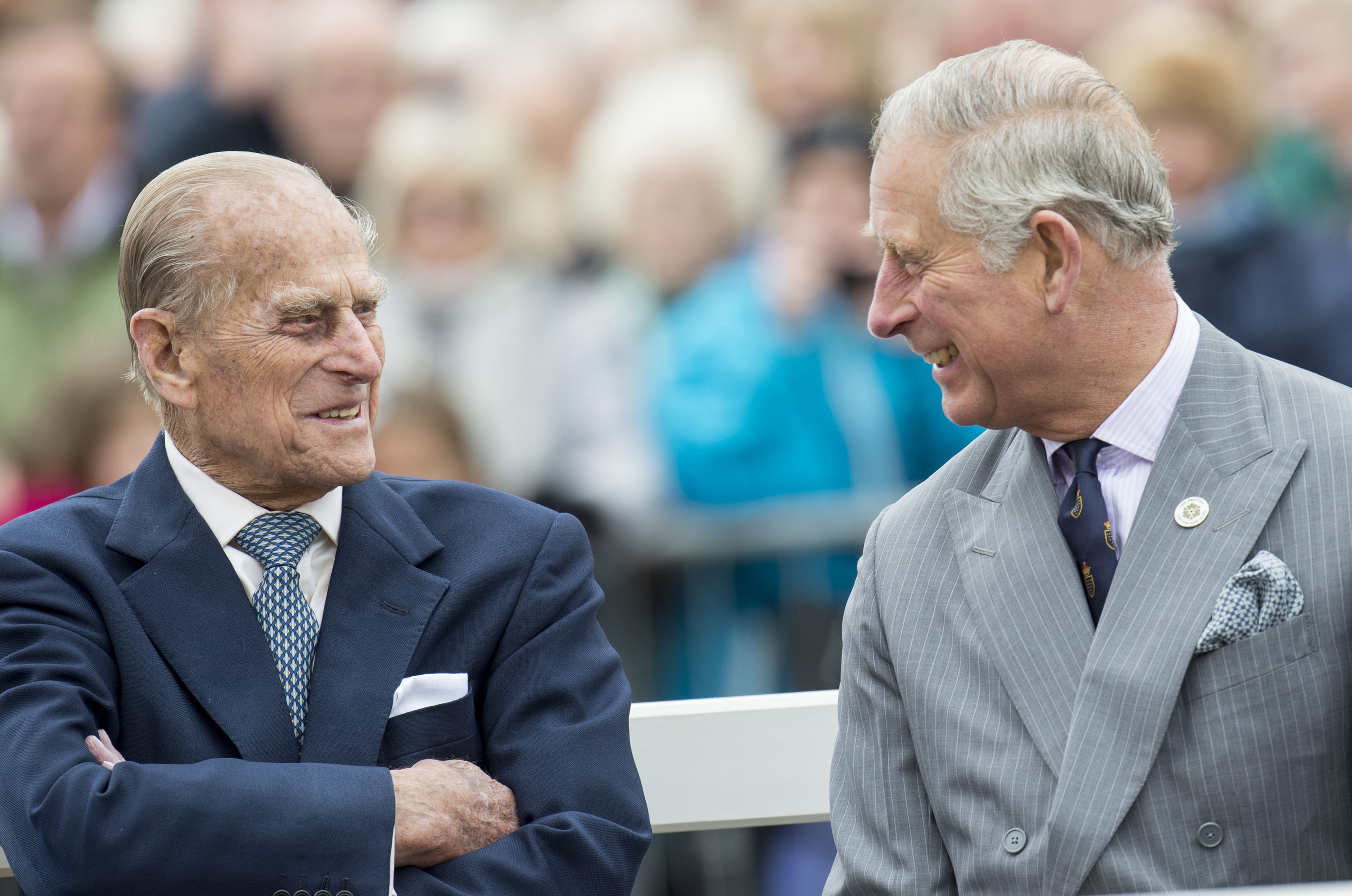 Prince Charles and Prince Philip smiling at each other