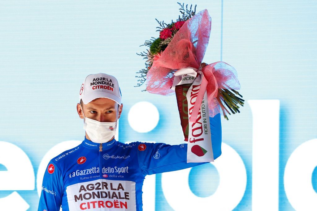 Team AG2R rider Frances Geoffrey Bouchard celebrates his best climbers blue jersey on the podium after the twelfth stage of the Giro dItalia 2021 cycling race 212 km between Siena and Bagno di Romagna on May 20 2021 Photo by Luca Bettini AFP Photo by LUCA BETTINIAFP via Getty Images