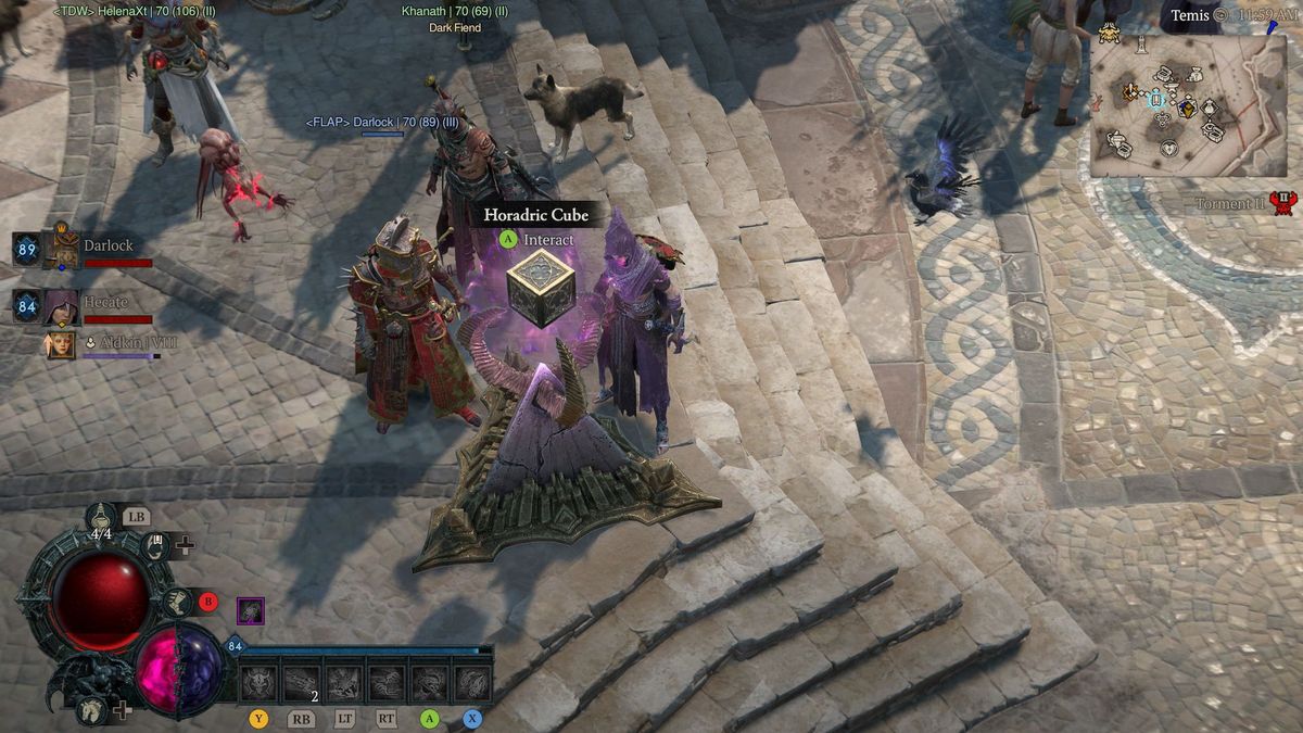 Video game scene showing characters standing on a cobblestone path around a glowing Horadric Cube.
