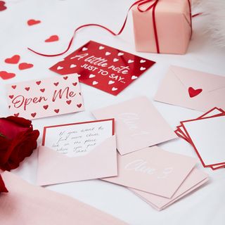 letter with envelopes and rose gift