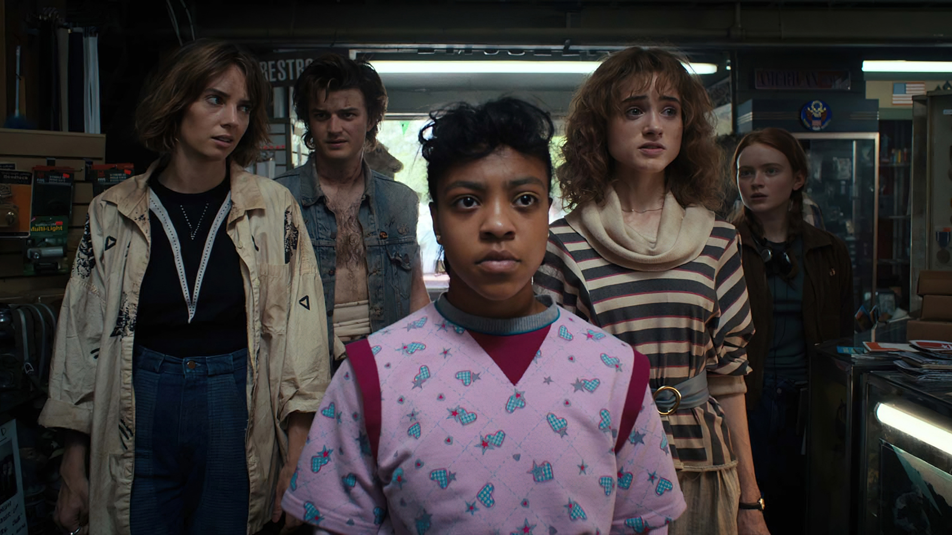 Erica, Nancy, Steve, Robin, and Max look at somebody off screen in Stranger Things season 4 volume 2