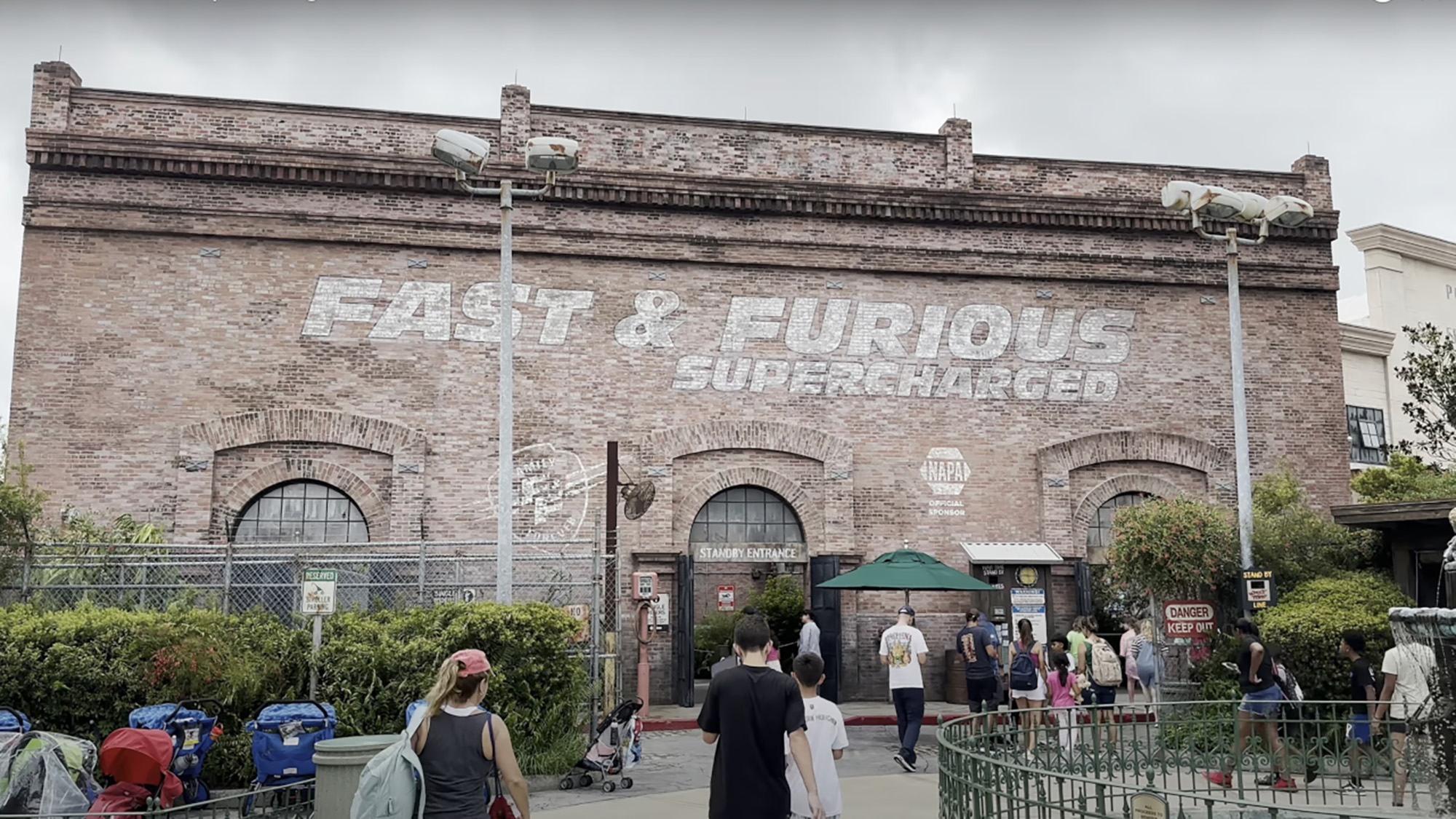 The painted outside of the Fast &amp; Furious Supercharged ride at Universal Orlando with people swarming in. 