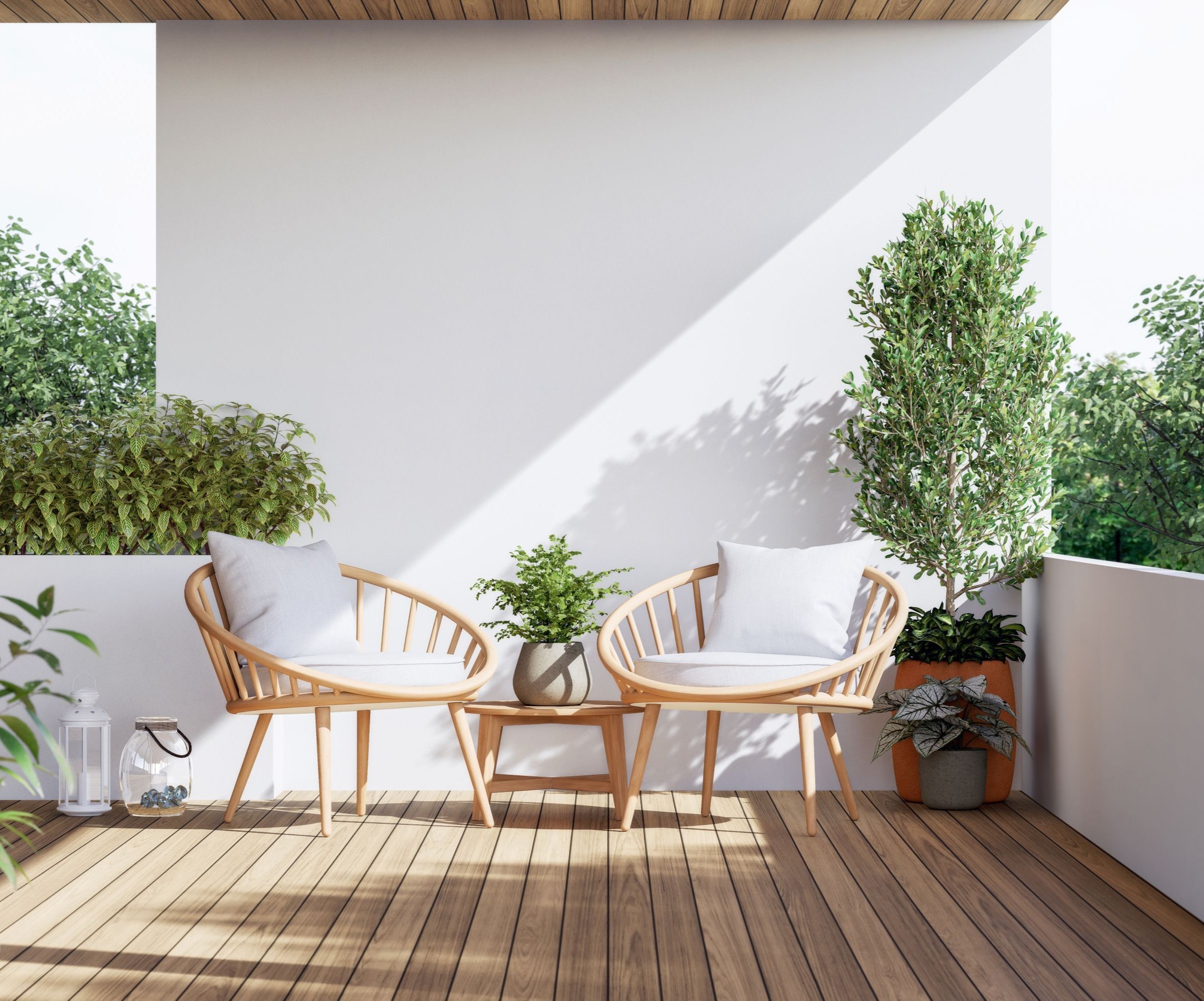 A balcony with wooden flooring and two wooden chairs