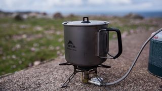 An MSR Titan Kettle on a small camping stove.