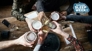 A group of friends toast each other with alcoholic drinks
