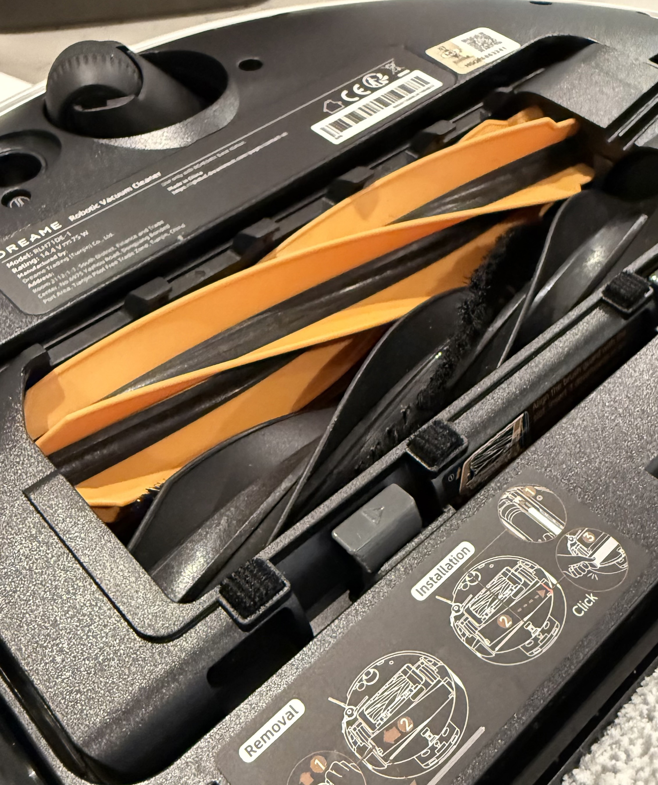 Detailed view of the Dreame Aqua10 Ultra Roller orange and black main brush roller inside the housing