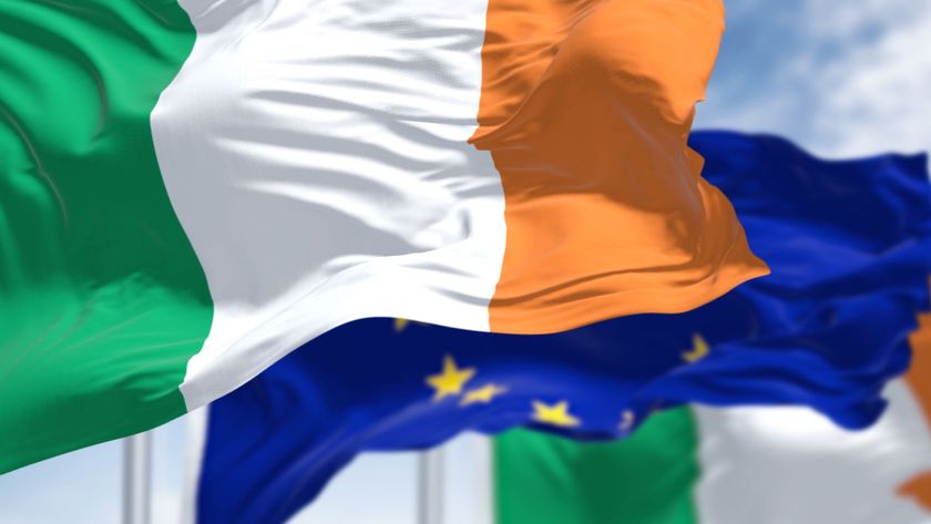 Detail of the national flag of Ireland waving in the wind with blurred European Union flag - stock photo