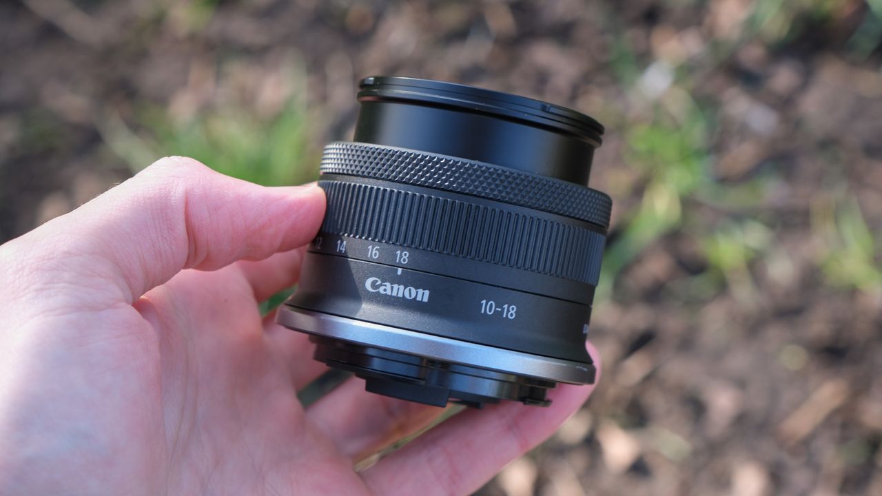 Canon RF-S 10-18mm lens held in a hand