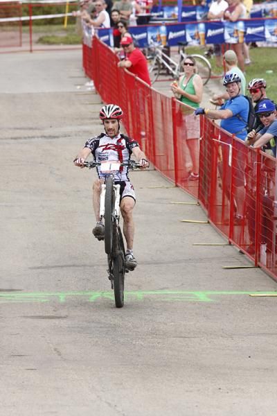 Derek Zandstra wheelies across the line for the win