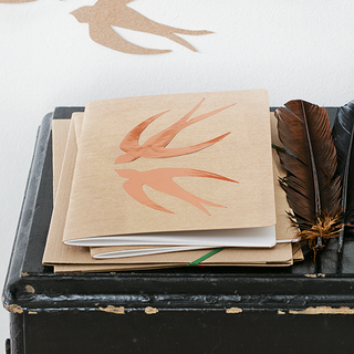 room with bird printed wall feather and bird printed notebook