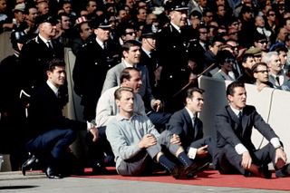 Norman Hunter (top) watches the 1966 World Cup final from the sidelines