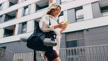 Girl walking carrying a gym bag