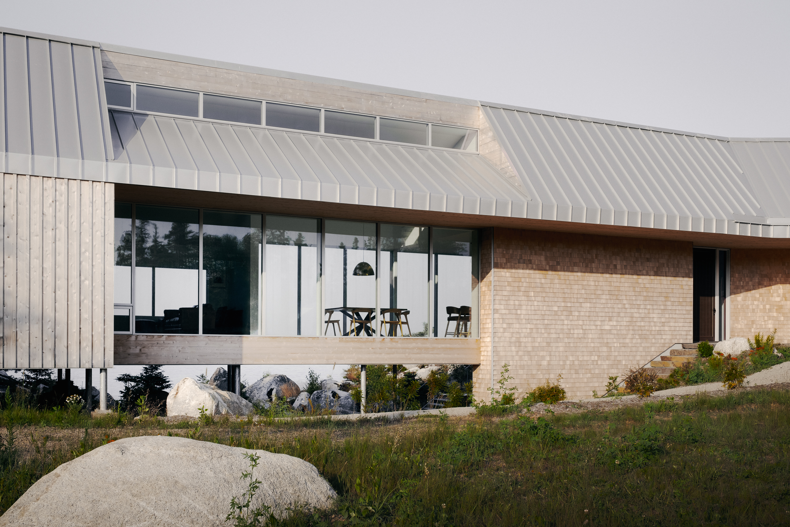 view of East River Residence, a delicate Nova Scotia house made of glazing and timber and open to rugged landscape vistas