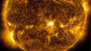 The sun fired off a moderate-sized solar flare (center) on May 4, 2022.
