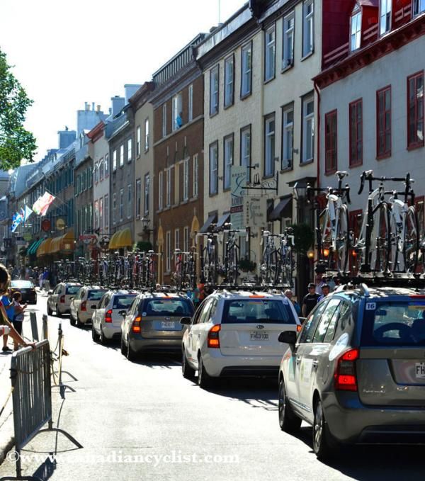 The team cars make their way through the old city.