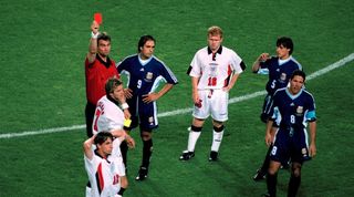 England v Argentina - Referee Kim Milton Nielsen shows the red card to David Beckham as Paul Scholes (16) looks accusingly at Argentinean captain Diego Simeone (8) who was involved in the incident - Gary Neville (12) Gabriel Batistuta (9) and Matias Almeyda (5). (Photo by Mark Leech/Getty Images)