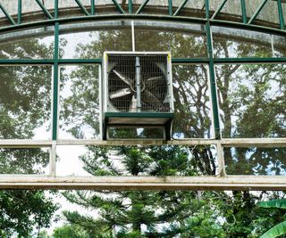 greenhouse evaporative cooling system mounted on glass