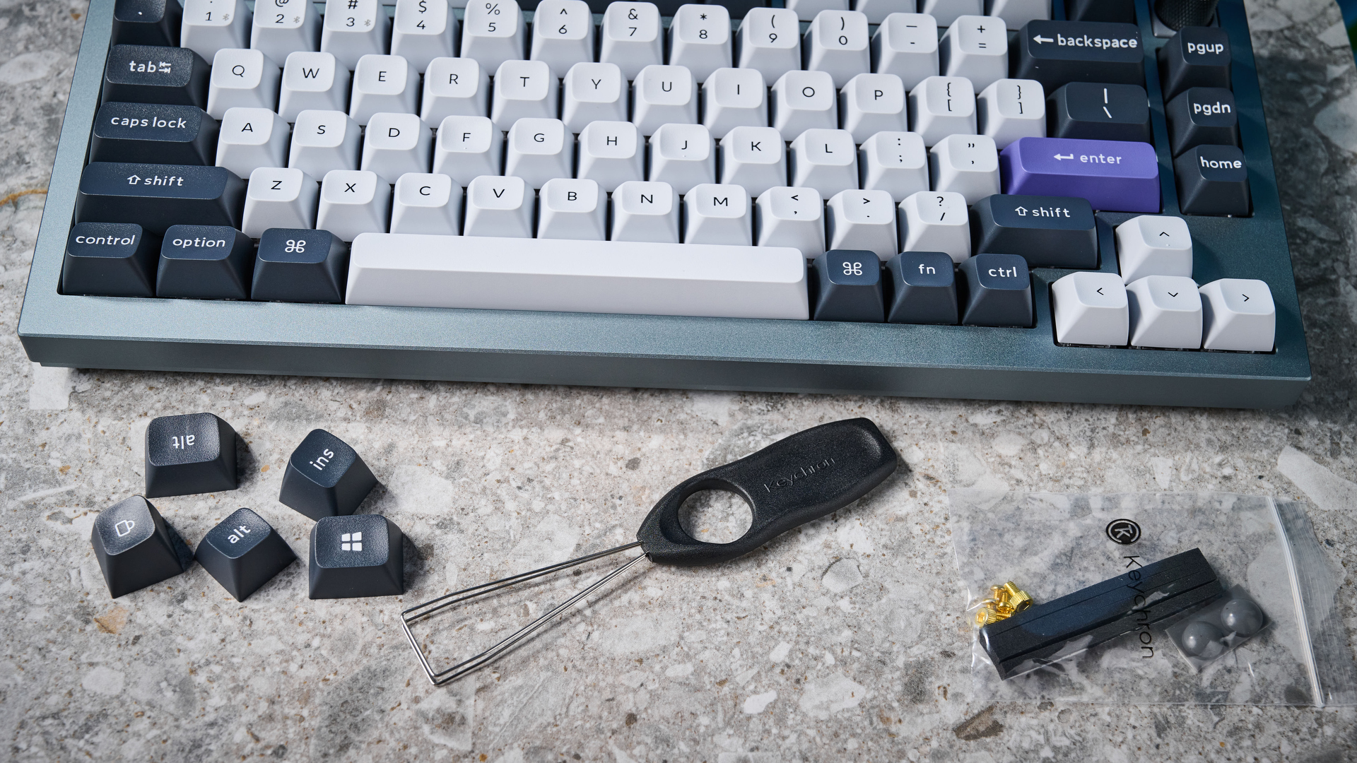 A photo of the Keychron Q1 Pro in gray aluminum with white, black and purple keycaps.