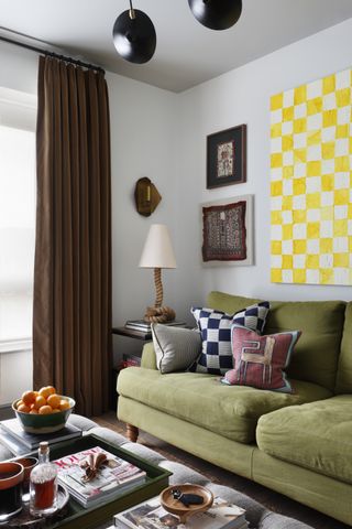 small living room with green sofa and yellow art