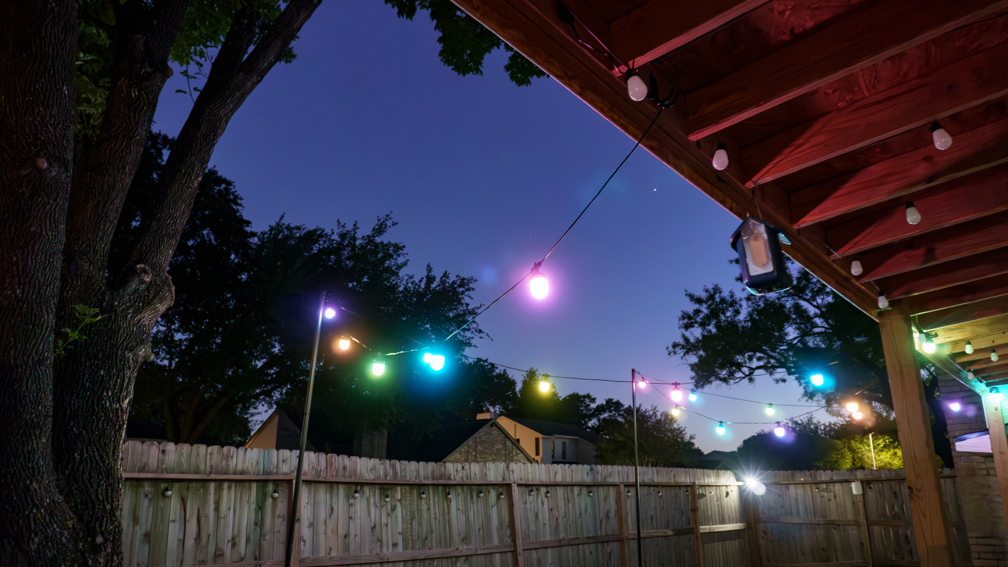 Govee's Outdoor Chromatic String Lights installed in a yard and turned on at night