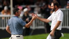 Rory McIlroy and Scottie Scheffler celebrating on the golf course