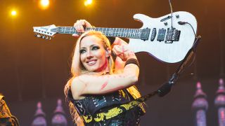 Nita Strauss playing her guitar on stage