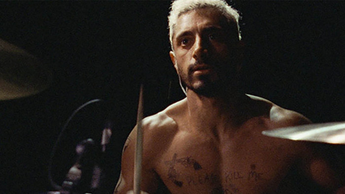 Riz Ahmed playing drums