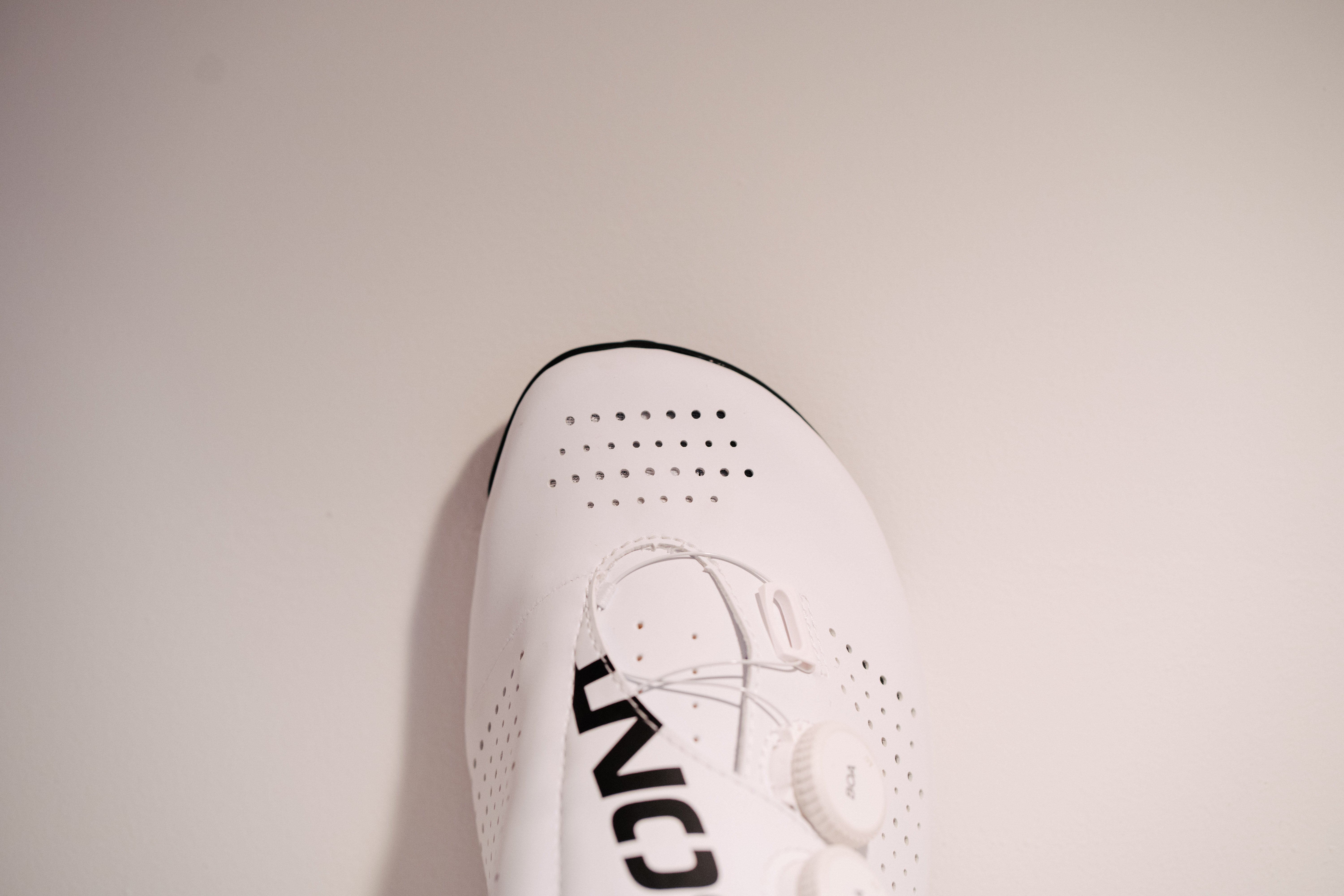 A white bicycle shoe on a shelf