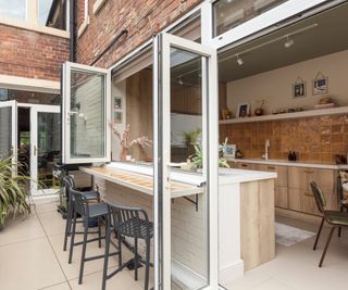 bifold windows and doors on kitchen creating kitchen/bar area