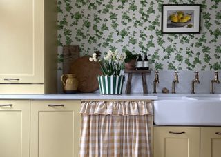 yellow kitchen with green patterned wallpaper