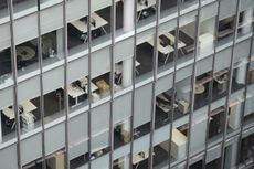 A photo peering inside the windows of an empty office building