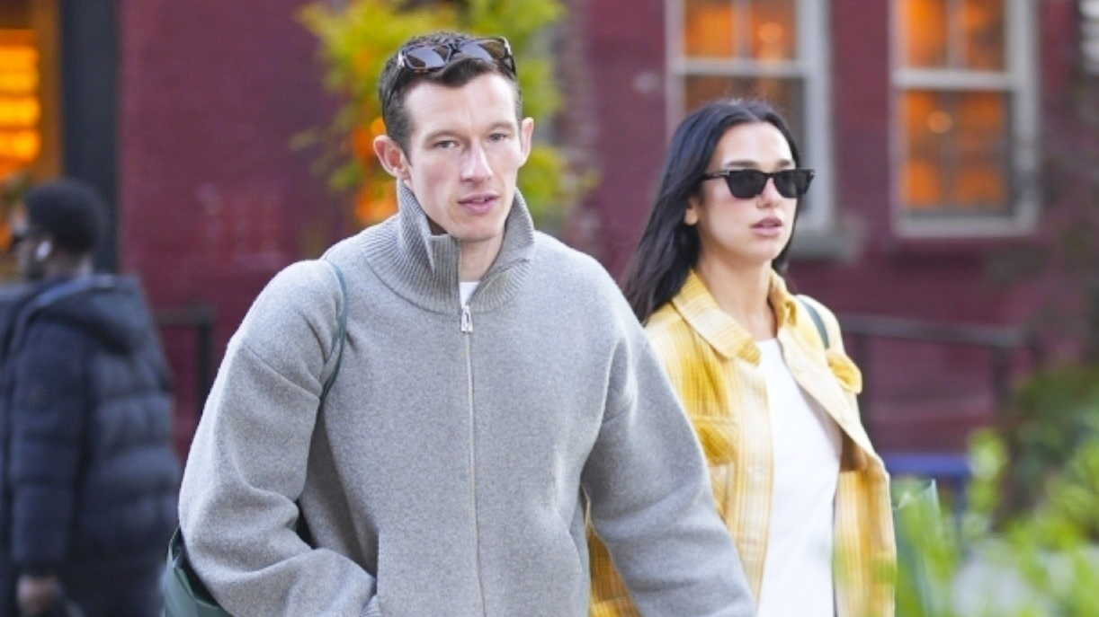 Dua Lipa wearing a yellow plaid shirt and jeans with Callum Turner in NYC