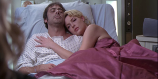 Grey's Anatomy Izzie Stevens, wearing a prom dress, lies with Denny Duquette in his hospital bed