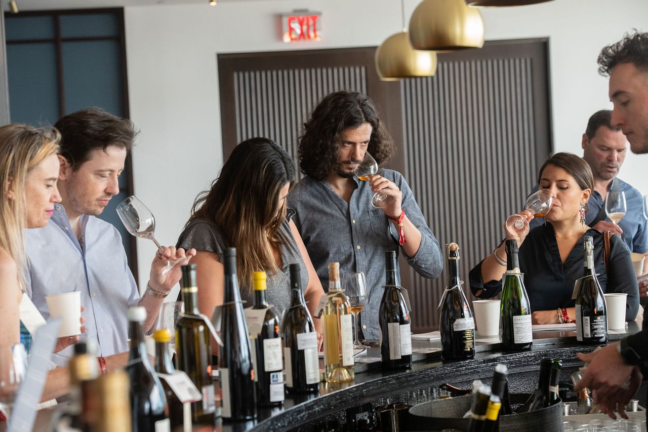 A group tasting various wines at the bar