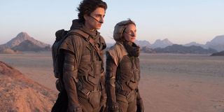 Dune Timothee Chalamet and Rebecca Ferguson wearing stillsuits in the desert