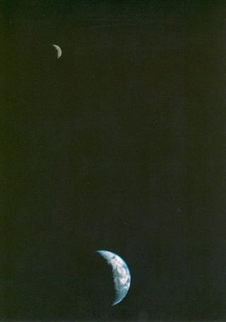 This NASA picture of the Earth and the moon in a single frame, the first of its kind ever taken by a spacecraft, was recorded Sept. 18, 1977, by Voyager 1 when it was 7.25 million miles (11.66 million kilometers) from Earth. The moon (top) is beyond the Earth as viewed by the space probe. Because the Earth much brighter than the moon, the moon was artificially brightened by a factor of three by computer enhancement so that both bodies would show clearly in the image.