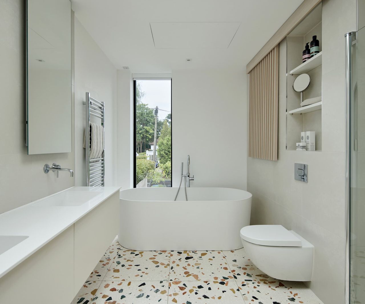 A white bathroom with a polka dot pattern porcelain floor