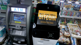 a Bitcoin ATM in a convenience store beside a traditional ATM