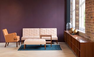 Scandinavian furniture in front of maroon coloured wall