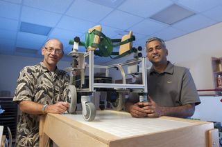 Cole Galloway (left) and Sunil Agrawal (right) with a baby mobility robot.