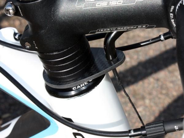 The carbon fiber front brake housing stop weighs next to nothing and looks trick but isn't our cup of tea. There's no provision to lock its position on the steerer and lower stem positions require it to be run well off-center