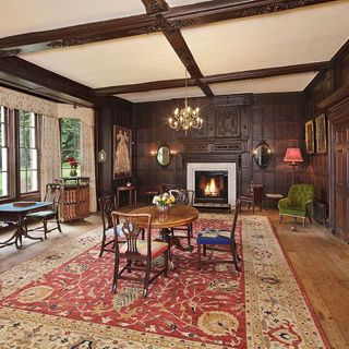 hall with fireplace wooden flooring and table with chair