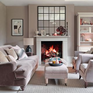 A grey living room with fireplace and large mirror