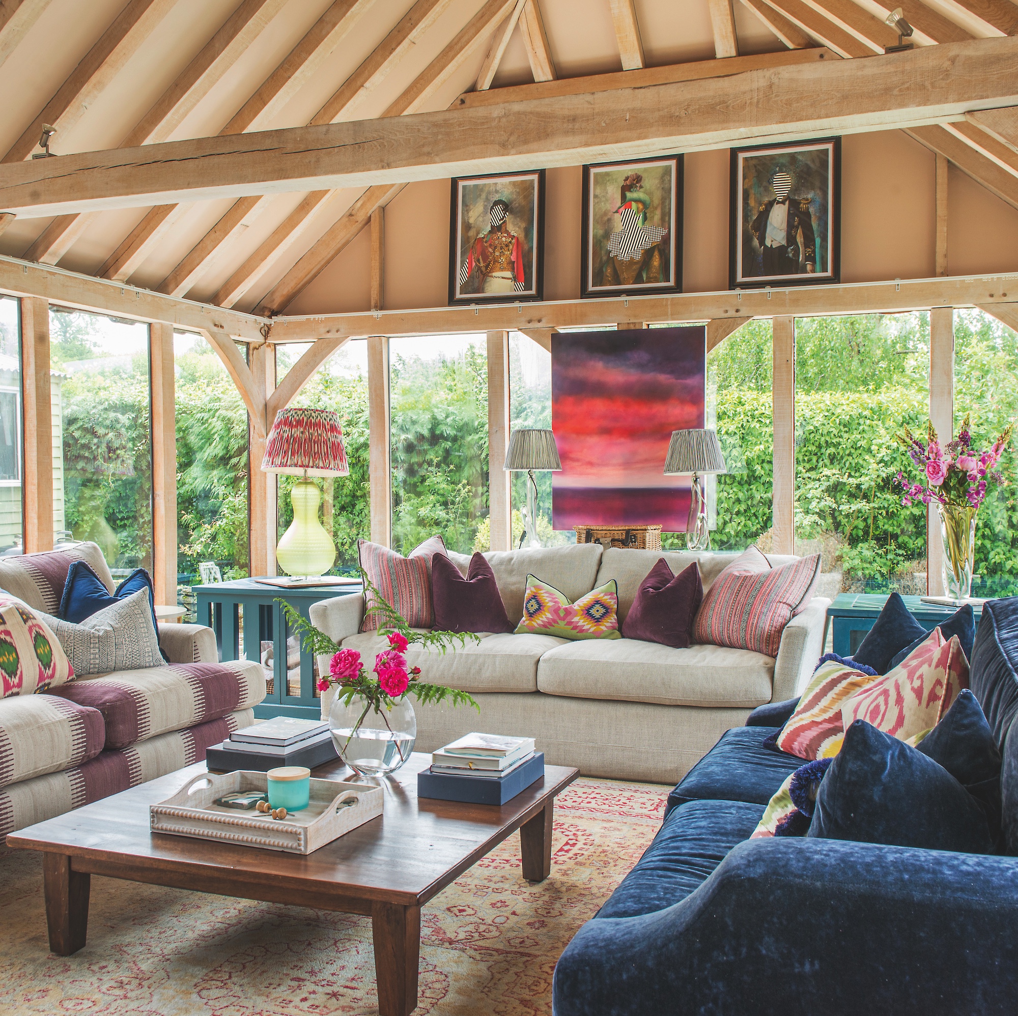 timber frame garden room interior with three sofas surrounding square coffee table