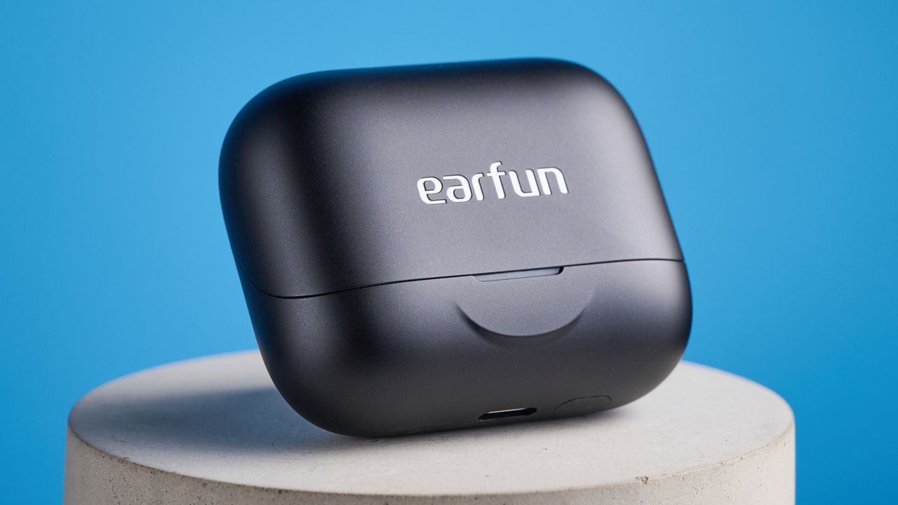 the earfun air pro 4+ earbuds in black showing the ear tips, charging case, and being worn