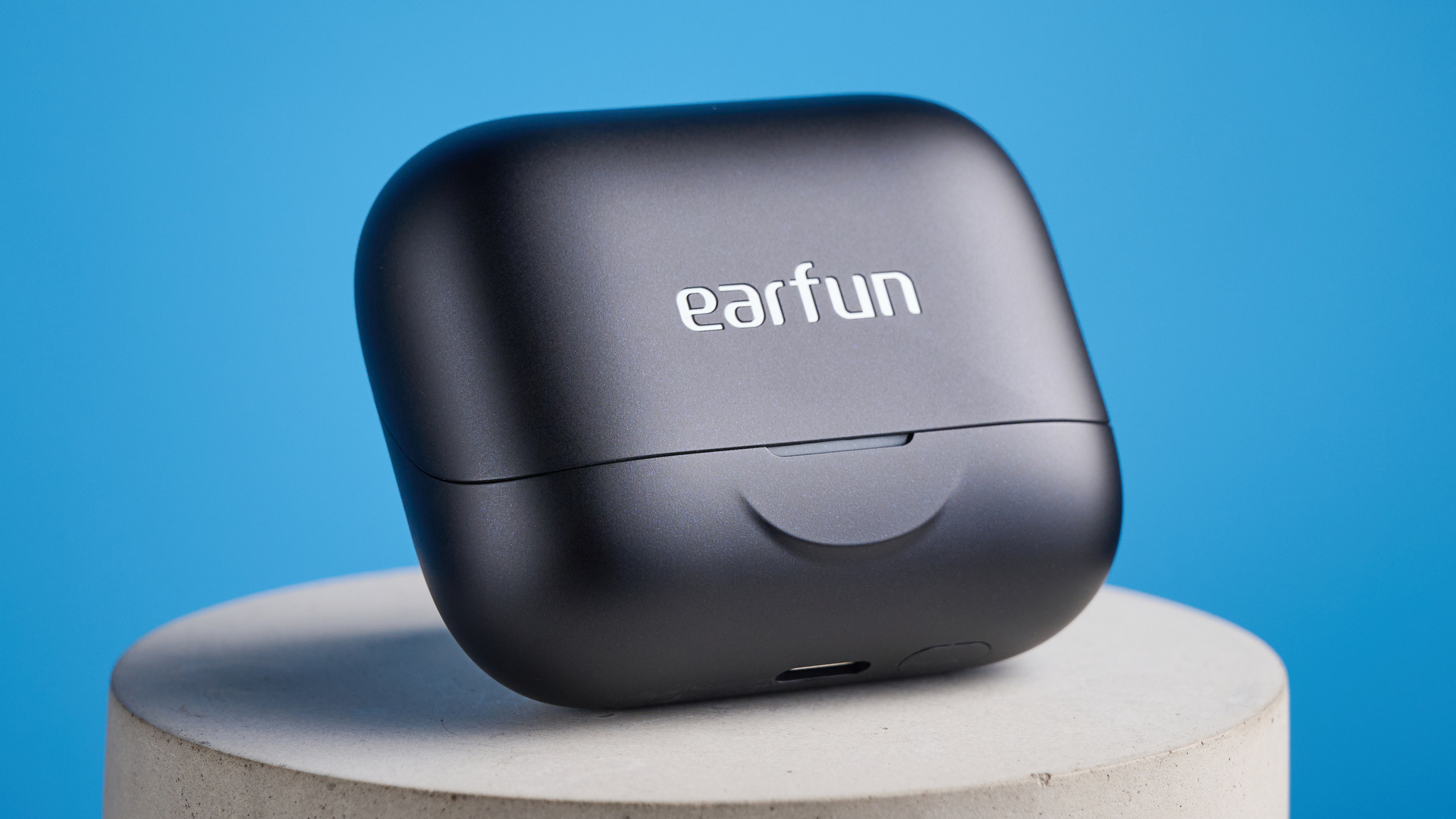 the earfun air pro 4+ earbuds in black showing the ear tips, charging case, and being worn